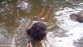 Attractive African village girl bathing in the river